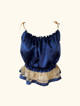 Load image into Gallery viewer, product image of the front of a gathered blue silk camisole the lace hip frill flares out and is trimmed in blue silk.