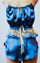 Load image into Gallery viewer, A back view of a woman wearing the tap pants with the camisole. The roses are visible at the sides the back has a slight v opening and is tied with a bow that leads into the waistband.