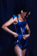 Load image into Gallery viewer, A photo of a woman wearing the Anna Stays and Tap pants viewed from the side. Both sit on the wiast and the front of the stays sit over the front of the tap pants.