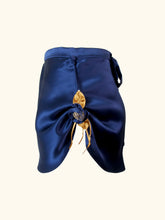 Load image into Gallery viewer, A side view product image of the Anna tap pants. The loop holding the hem up is attached to a small covered button at the waistband.