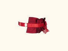 Load image into Gallery viewer, side view of dark red garter. The ruffles extend half way round the neck. The back is red lingerie elastic with gold hardwear.