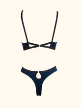 Load image into Gallery viewer, A back view of the Artemis bralette and thong on a a stand. The round keyhole on the thong and the triangle shapes created by the fastening straps on the bralette compliment each other well.