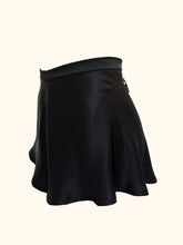 Load image into Gallery viewer, The side front view of the Emmeline black silk tap pants, showing the bias cut fabric flaring over the hips. The front of the tap pants is plain.