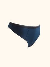 Load image into Gallery viewer, A side front view of the Artemis bamboo thong on a stand, showing the side seams and the gentle curve of the leg.