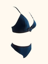 Load image into Gallery viewer, A side front view of the Artemis bralette and thong on a stand.