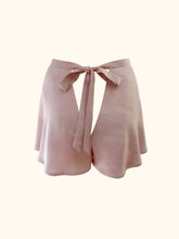 Load image into Gallery viewer, The back of the avocado bamboo tap pants on a stand. They fasten at the back with a bow that extends out of the waistband and is around 1 inch wide. There is a triangular gap below the bow which would expose the lower back. The pink is a dusky, natural and warm tone.