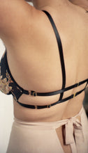 Load image into Gallery viewer, The side back of the Avocado tap pants worn with the Josephine bralette. The bralette has a strappy back which compliments the triangular cut out below the bow on the tap pants. The tap pants are a dusky pink.