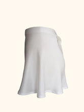Load image into Gallery viewer, Side view of the ivory sandwashed Emmeline tap pants. The bias cut silk flows over the hips in gentle folds.