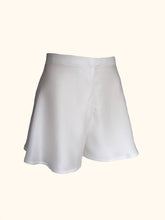 Load image into Gallery viewer, A side front view of the ivory sandwashed Emmeline tap pants showing the gentle flare of the silk from the waist over the hips.