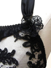 Load image into Gallery viewer, A close up of the black lace rosettes on the black Sarah bralette. The centre is decorated with black glass beads.