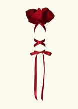 Load image into Gallery viewer, A view of the sleeve puff from the side. The height of the puff is around 4", the ribbon attaches in the centre and criss crosses down the arm, tying in a bow by the elbow.