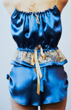 Load image into Gallery viewer, A back view of a woman wearing the tap pants with the camisole. The roses are visible at the sides the back has a slight v opening and is tied with a bow that leads into the waistband.

