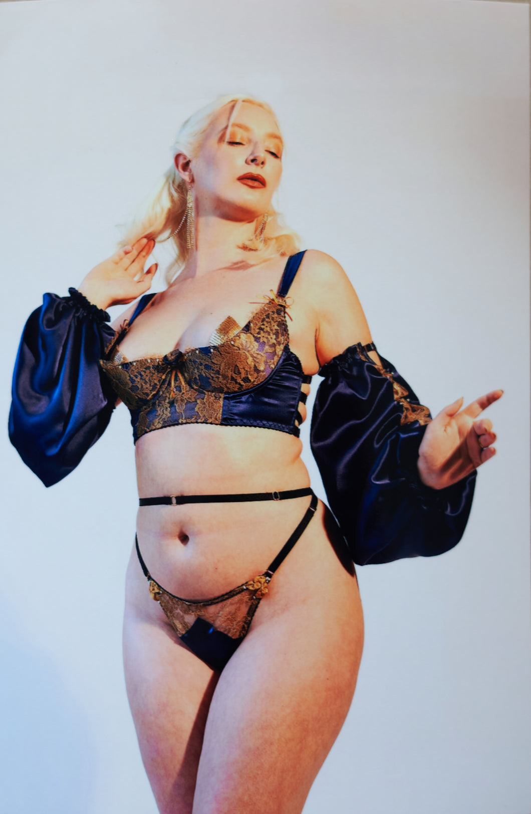 an image of a woman wearing the Anna bra sleeves and thong. All are made in blue silk with gold lace.