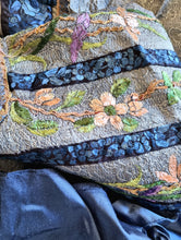 Charger l&#39;image dans la galerie, Textured grey blue silk with peach embroidered flowers and black and blue embroidered ribbon details. Blue silk binding shown next to it.
