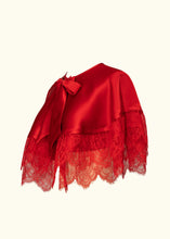 Load image into Gallery viewer, The side front of the Olenska cape-let showing the curve of the hem down from the shoulders and the sheer floral lace. The neck is bound in silk.
