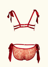 Cargar imagen en el visor de la galería, A back view of the Olenska Bralette and knickers. The red satin strap detail across the hips of the knickers, above where the lace scoops down echos the straps on the back of the bralette.
