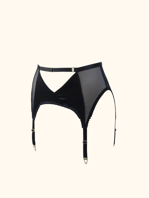 The front of the Win suspender belt. The belt has 4 straps and gold hardware. The front panels are silk and cross over to create an inverted triangle cut out below the waist. An adjustable waistband strap runs above this.