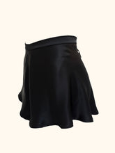 Cargar imagen en el visor de la galería, The side front view of the Emmeline black silk tap pants, showing the bias cut fabric flaring over the hips. The front of the tap pants is plain.
