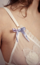 Cargar imagen en el visor de la galería, A close up of the blue bow at the top of the cup on the Lily bralette. The satin ribbon is hand dyed and has variation of tone in blue and pink. The ribbon is around 1cm wide.
