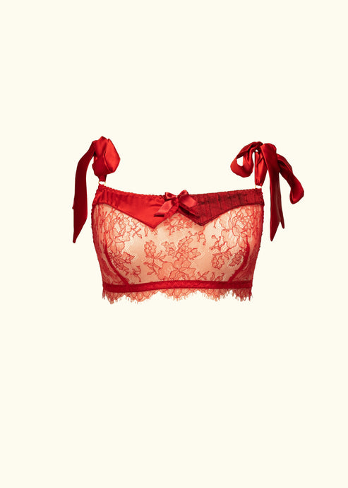 The Olenska lace bralette from the front. The lace is a red floral pattern, there is a lace frill under the band. The neck line is trimmed with red silk panels and a bow. It is a bandeau style.