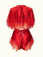Load image into Gallery viewer, A back view of the Olenska tap pants and cape-let. Both use the same red silk and lace trim. This shows a styling option. The lace extends to the top of the waistband of the tap pants.
