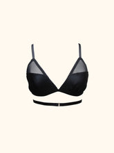 Cargar imagen en el visor de la galería, The front of the Nina bralette. The black straps lead directly up over the shoulders from the cups. There is no decoration where they join. The band is one elastic strap which wraps around the body and fastens at the front with a gold G hook. All straps are adjustable.
