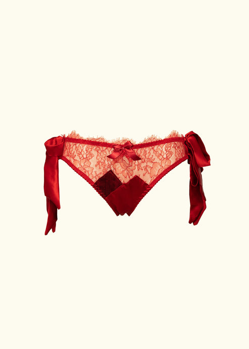 The Olenska lace knickers from the front. The sides fasten with double side bows in red satin which hang down by the hips. The knickers are hips level and feature a crossover silk panel design at the crotch. There is a bow trimming the hip line.