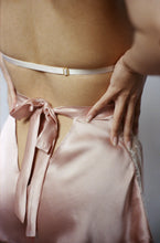 Cargar imagen en el visor de la galería, A close up of the back of the Sarah tap pants. They fasten with a bow that extends from the waistband and is around 1 inch wide. There is a triangular cut out beneath the bow that shows the lower back.
